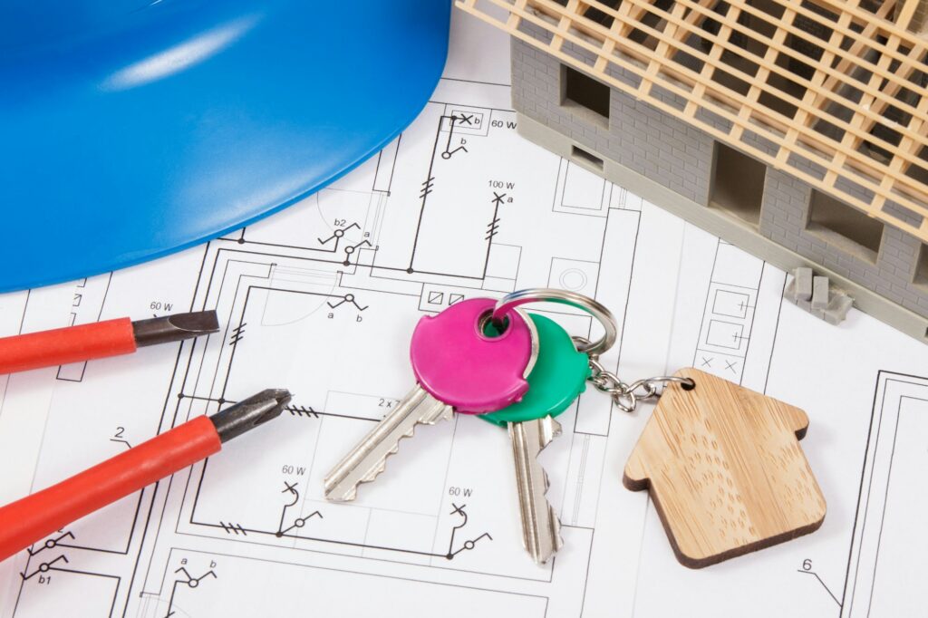 Home keys, electrical construction diagrams and small house under contruction